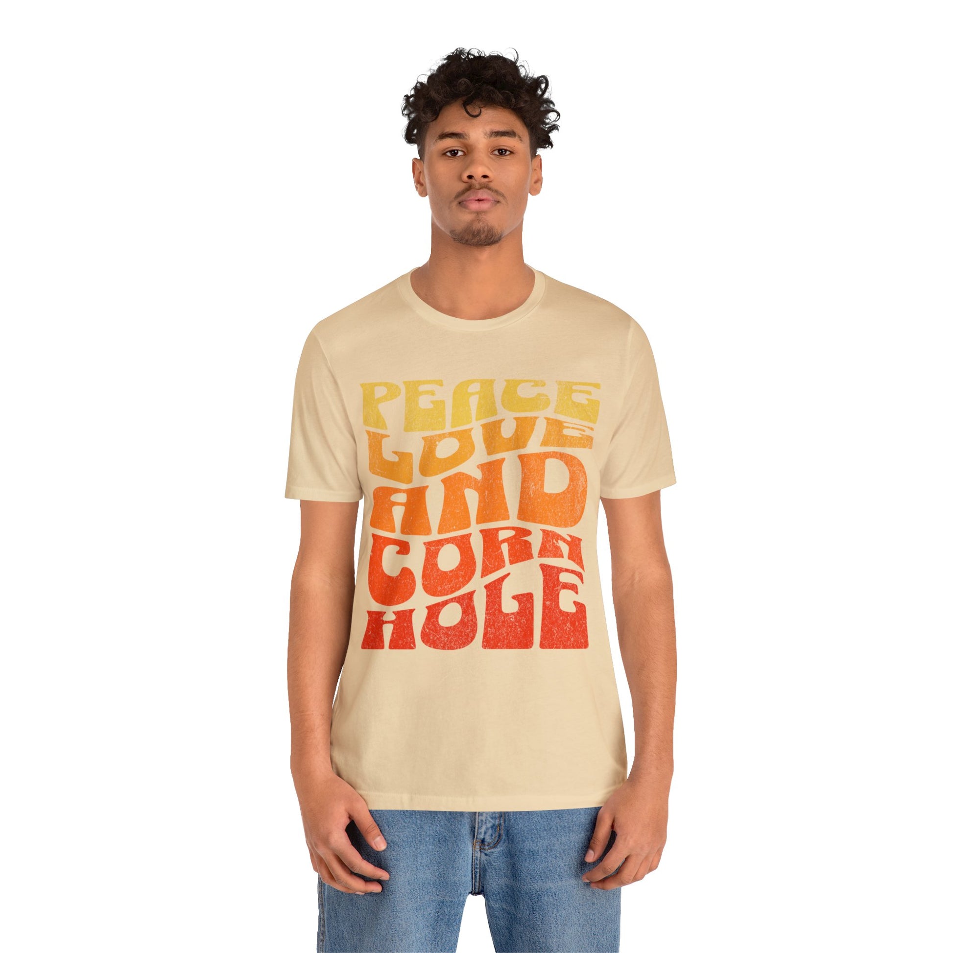 Young man wearing Peace Love and Cornhole Groovy Boho Soft Cotton Bella Canvas Tee Cornhole T-Shirt (Unisex)